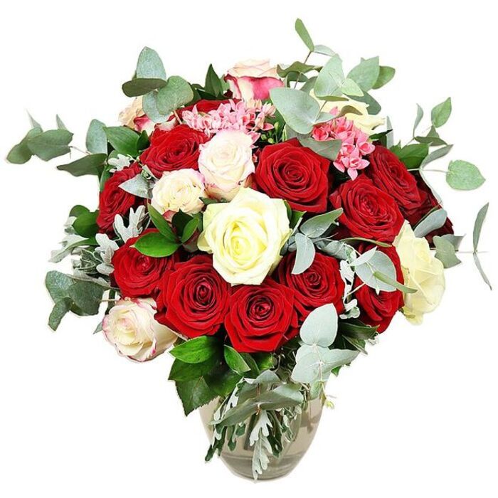 Against a crisp white backdrop, a striking bouquet of roses in a clear, gently rounded glass vase showcases a rich palette of reds, whites, and soft pinks, evoking the mood of a romantic evening in Addington. The arrangement is densely packed, with more than two dozen roses forming a lush, domed silhouette that feels both opulent and carefully considered. Deep red and vivid scarlet roses dominate the composition; some stand tall and partially closed, their velvety petals spiralling tightly, while others open wide to reveal plush, layered centres that almost seem touchably soft. Woven between these passionate hues are creamy white and ivory roses, with a few petals edged in the faintest blush pink, bringing a gentle glow that balances the intensity of the reds. Here and there, clusters of small, bright pink filler flowers, likely miniature carnations or similar blossoms, peek between the larger blooms, lending a playful texture and an extra pop of colour. Surrounding and threading through the roses are abundant sprigs of rounded, blue-green eucalyptus leaves, their slightly matte surface and distinctive shape adding a modern, airy contrast and an imagined cool fragrance. Dark green foliage and touches of silvery-green greenery anchor the base of the design, ensuring the bouquet feels full, grounded, and naturally abundant, as though freshly arranged in a local Addington flower shop. The vase itself, transparent and gently bulbous at the base, reveals the clean stems gathered neatly in clear water, offering a simple counterpoint to the complexity above. The overall impression is one of classic, timeless romance, perfect for Addington deliveries celebrating anniversaries, engagements, or any moment that calls for a grand, heartfelt expression of love.